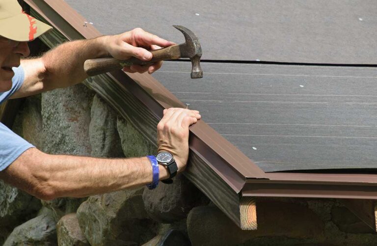 A squirrel-sized opening near a roof vent with disturbed attic insulation and nesting material visible inside.